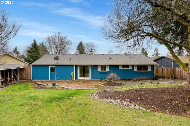 rear view of property with a lawn and a fenced backyard