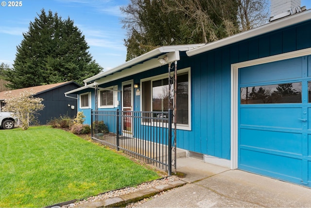 property entrance featuring a lawn and an attached garage