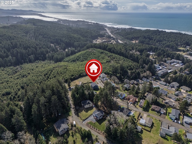 1852 SE Oar Dr, Lincoln City, OR 97367 - aerial view of property and surrounding area featuring a heavily wooded area, a large body of water, and nearby suburban area