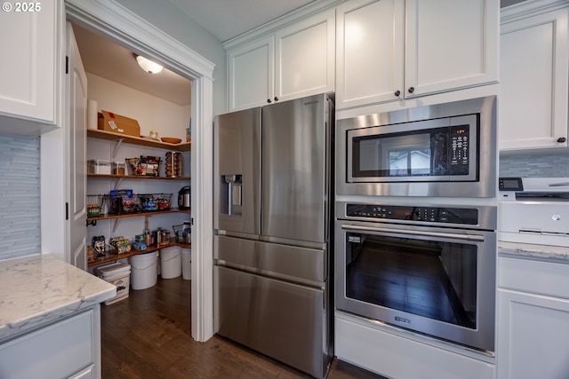 1852 SE Oar Dr, Lincoln City, OR 97367 - kitchen featuring stainless steel appliances, white cabinets, dark wood-style floors, and light stone countertops