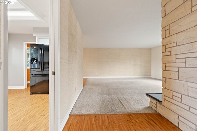 empty room featuring baseboards and light wood-style floors