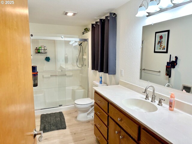 38434 Mckenzie Hwy, Springfield, OR 97478 - bathroom featuring a shower stall, wood finished floors, toilet, and vanity