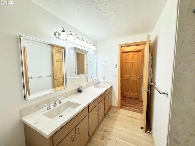 38434 Mckenzie Hwy, Springfield, OR 97478 - bathroom with wood finished floors, a textured ceiling, and double vanity