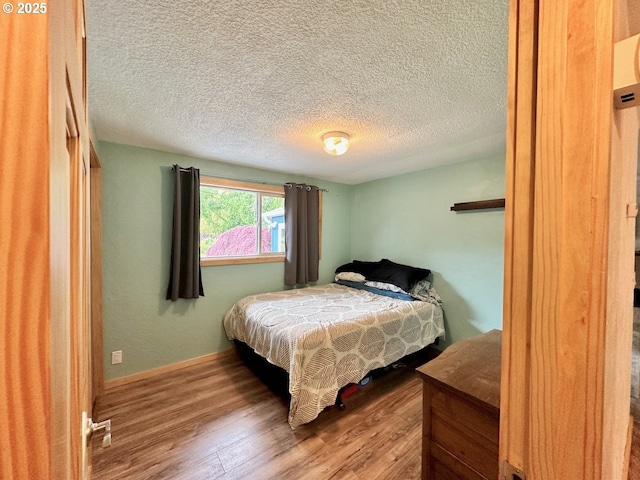 38434 Mckenzie Hwy, Springfield, OR 97478 - bedroom with wood finished floors and a textured ceiling