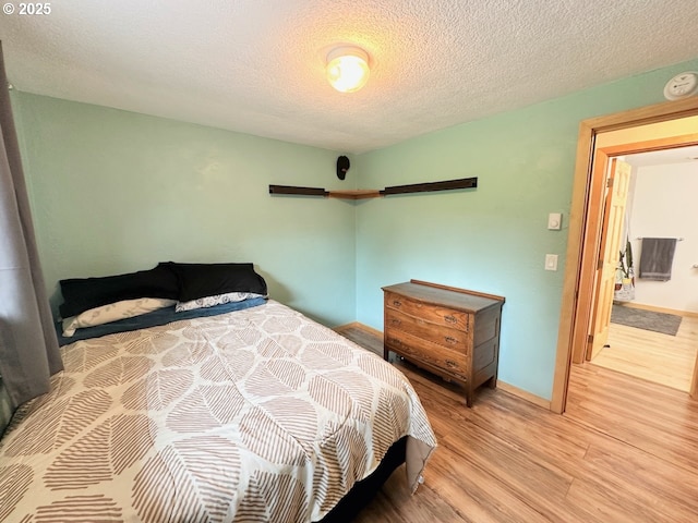 38434 Mckenzie Hwy, Springfield, OR 97478 - bedroom with light wood finished floors, baseboards, and a textured ceiling