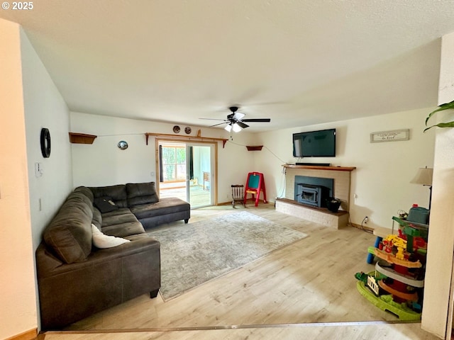 38434 Mckenzie Hwy, Springfield, OR 97478 - living area with wood finished floors, ceiling fan, and a fireplace with raised hearth