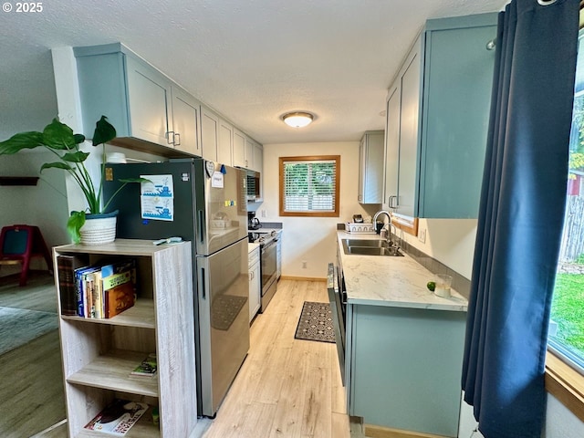 38434 Mckenzie Hwy, Springfield, OR 97478 - kitchen featuring a sink, appliances with stainless steel finishes, light countertops, light wood-type flooring, and healthy amount of natural light