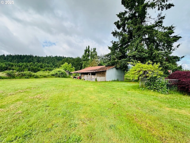 38434 Mckenzie Hwy, Springfield, OR 97478 - view of green lawn with a wooded view, an outdoor structure, and a pole building