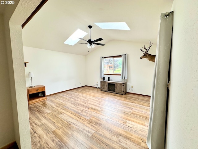 38434 Mckenzie Hwy, Springfield, OR 97478 - unfurnished living room with a skylight, vaulted ceiling, wood finished floors, and baseboards