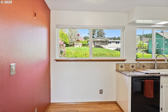 178 NE Tari Ln, Stevenson, WA 98648 - kitchen featuring a wealth of natural light, black dishwasher, light wood finished floors, and a sink