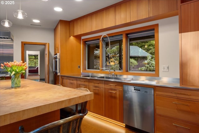 321 NW Hilltop Dr, Portland, OR 97210 - kitchen featuring stainless steel countertops, appliances with stainless steel finishes, brown cabinetry, plenty of natural light, and recessed lighting