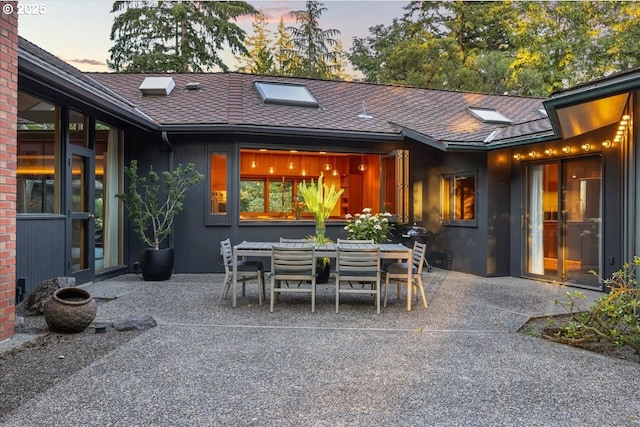 321 NW Hilltop Dr, Portland, OR 97210 - patio terrace at dusk featuring a patio and outdoor dining area