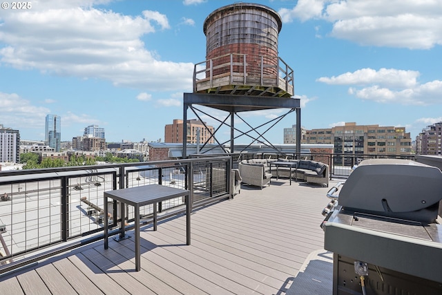 deck with a view of city, outdoor lounge area, and area for grilling
