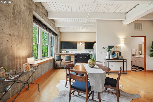 416 NW 13th Ave Unit 312, Portland, OR 97209 - dining room with light wood-style flooring and beam ceiling