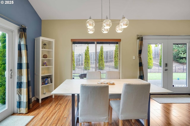 dining space featuring french doors, a wealth of natural light, and light wood-type flooring