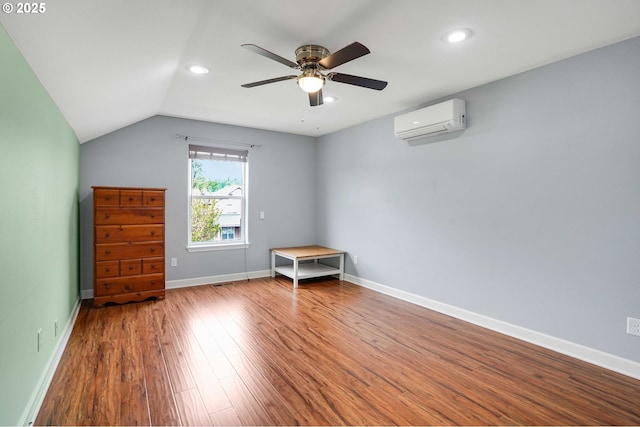 unfurnished room with wood finished floors, lofted ceiling, a wall mounted air conditioner, recessed lighting, and a ceiling fan