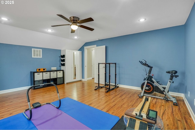 workout area featuring visible vents, baseboards, ceiling fan, and wood finished floors
