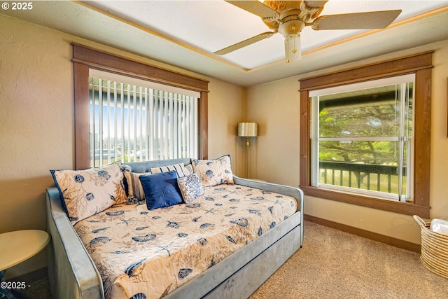 1201 NW Bayshore Dr, Waldport, OR 97394 - carpeted bedroom featuring multiple windows, baseboards, and ceiling fan