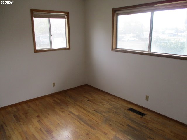1210 Alder St, Elgin, OR 97827 - unfurnished room with a wealth of natural light, wood finished floors, and visible vents