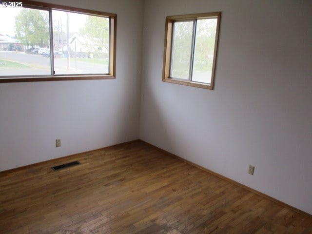 1210 Alder St, Elgin, OR 97827 - empty room featuring visible vents and wood finished floors