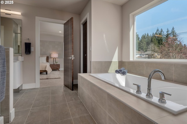 bathroom featuring tiled tub and tile patterned floors