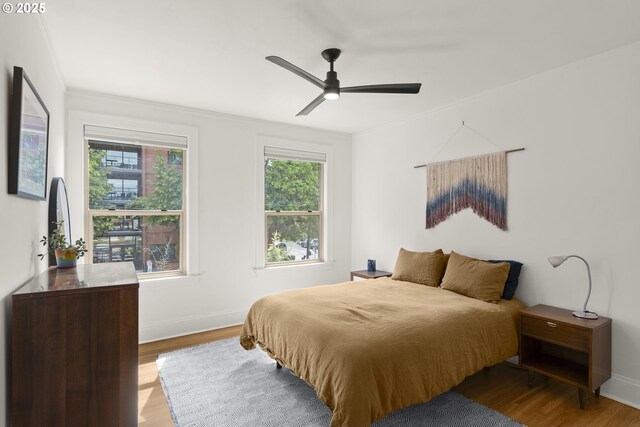 1529 SE Hawthorne Blvd Unit 204, Portland, OR 97214 - bedroom with ceiling fan, ornamental molding, baseboards, and wood finished floors