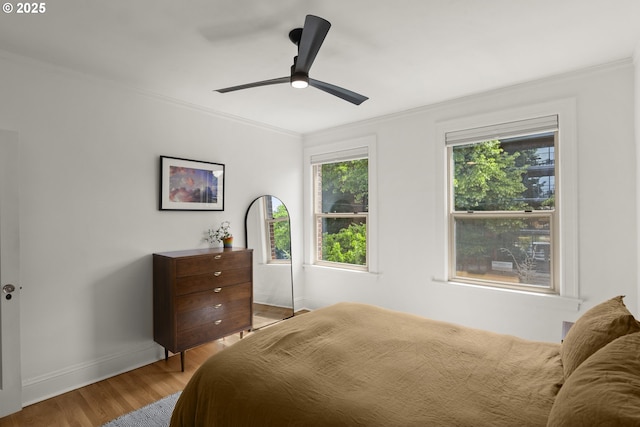 1529 SE Hawthorne Blvd Unit 204, Portland, OR 97214 - bedroom featuring baseboards, ornamental molding, a ceiling fan, and wood finished floors