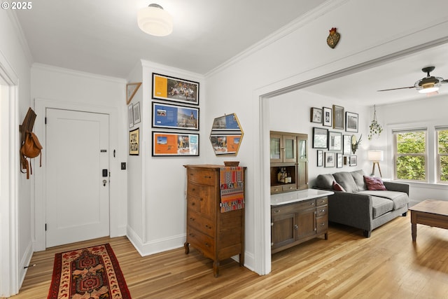 1529 SE Hawthorne Blvd Unit 204, Portland, OR 97214 - entryway with baseboards, ceiling fan, crown molding, and light wood-type flooring