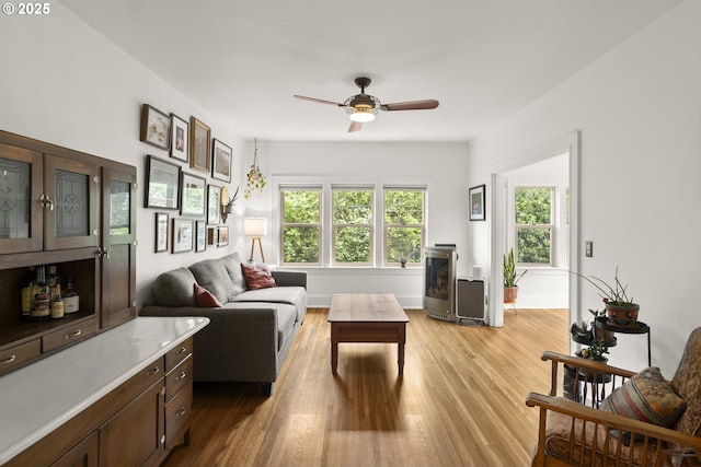 1529 SE Hawthorne Blvd Unit 204, Portland, OR 97214 - living area with light wood-type flooring, baseboards, and a ceiling fan