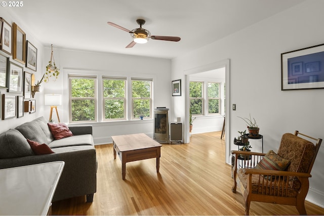 1529 SE Hawthorne Blvd Unit 204, Portland, OR 97214 - living room with a ceiling fan, baseboards, light wood-style flooring, and plenty of natural light