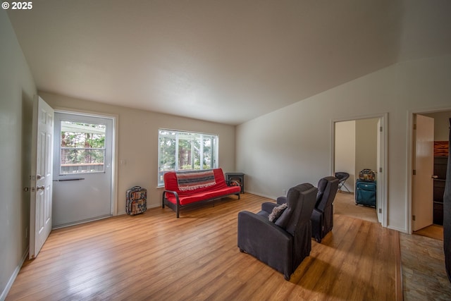 sitting room with lofted ceiling and wood finished floors