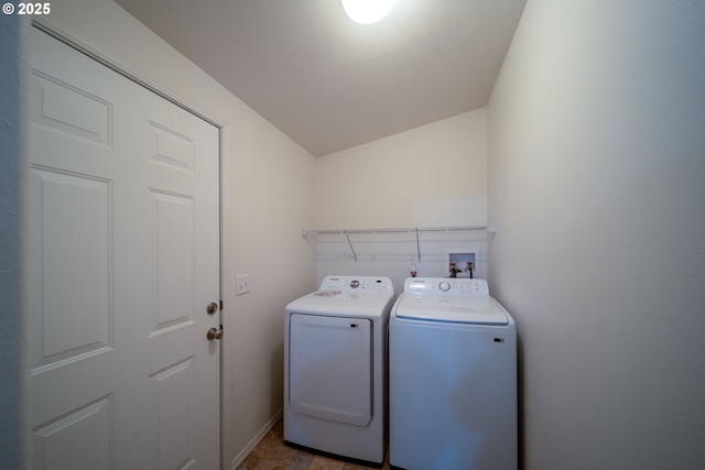 laundry room with laundry area, washing machine and dryer, and baseboards