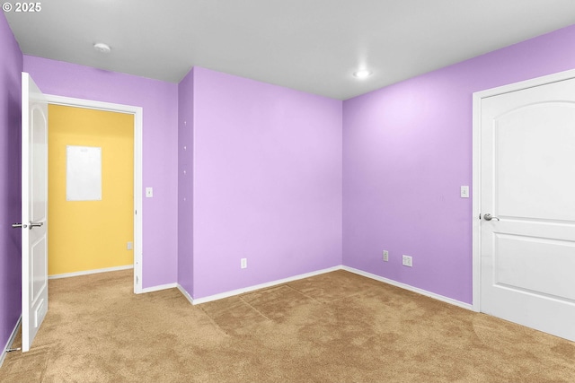 unfurnished room featuring recessed lighting, light colored carpet, and baseboards