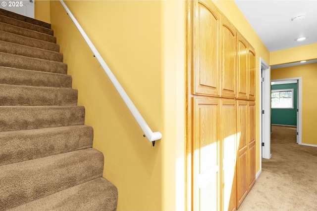 stairs with baseboards and carpet floors