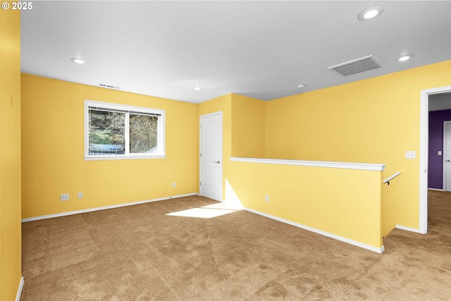 spare room featuring visible vents, recessed lighting, baseboards, and carpet floors