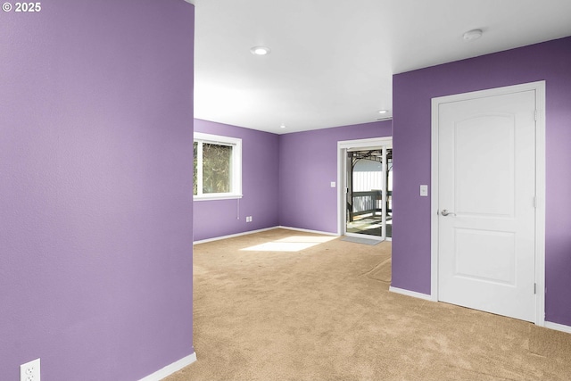 carpeted spare room with baseboards