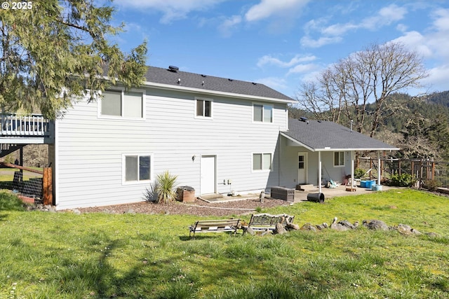 rear view of property with a yard, a patio area, fence, and central AC