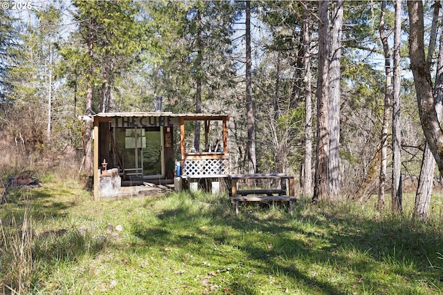 exterior space with a view of trees and an outbuilding