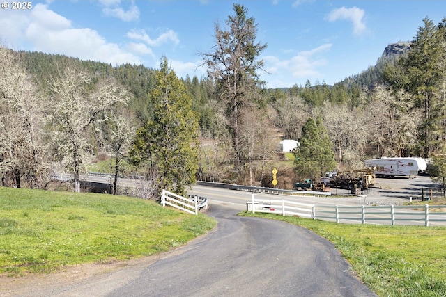 view of street featuring a forest view