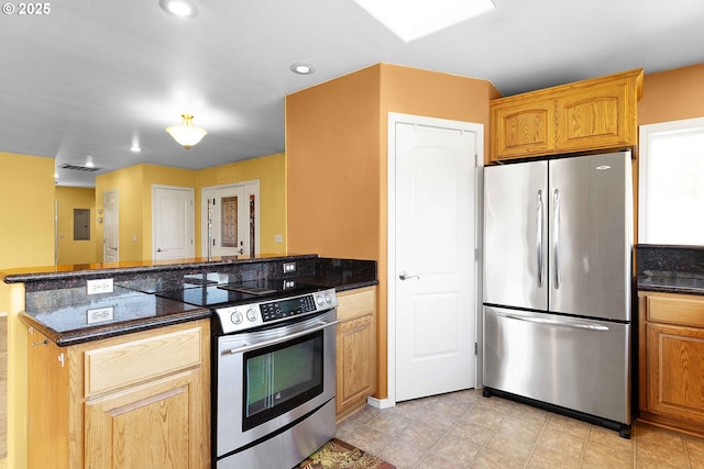 kitchen featuring visible vents, recessed lighting, stainless steel appliances, dark stone counters, and a peninsula