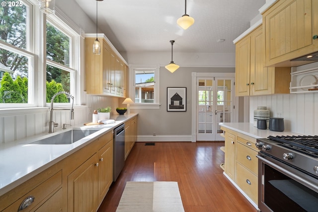 1905 N Sumner St, Portland, OR 97217 - kitchen with light brown cabinets, appliances with stainless steel finishes, light countertops, and hardwood / wood-style flooring