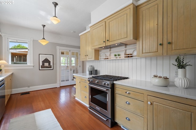1905 N Sumner St, Portland, OR 97217 - kitchen featuring appliances with stainless steel finishes, light brown cabinetry, wood finished floors, light countertops, and open shelves