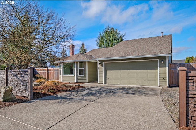 ranch-style home featuring fence, concrete driveway, an attached garage, a shingled roof, and a chimney