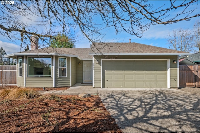 ranch-style home featuring aphalt driveway, roof with shingles, an attached garage, and fence