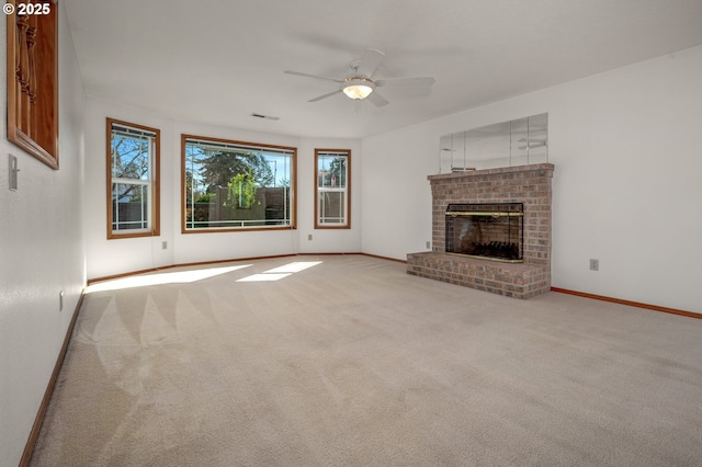 unfurnished living room featuring a brick fireplace, carpet flooring, baseboards, and visible vents