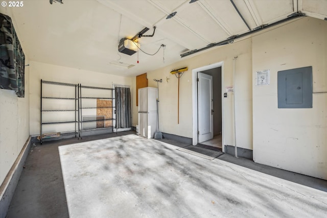 garage with a garage door opener, white refrigerator, and electric panel