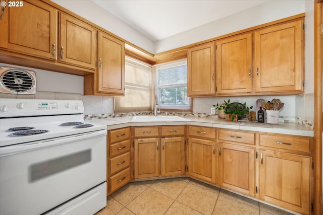 kitchen featuring light tile patterned flooring, white electric stove, decorative backsplash, and sink