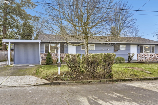 ranch-style house with a carport and a front lawn