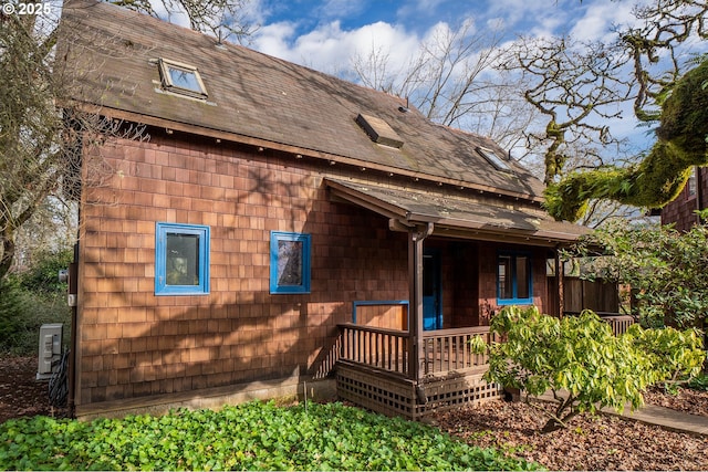 back of property featuring a porch