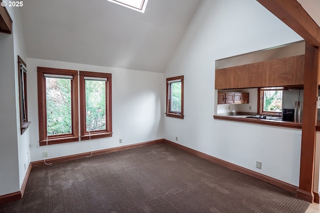 unfurnished living room featuring plenty of natural light, carpet floors, and high vaulted ceiling